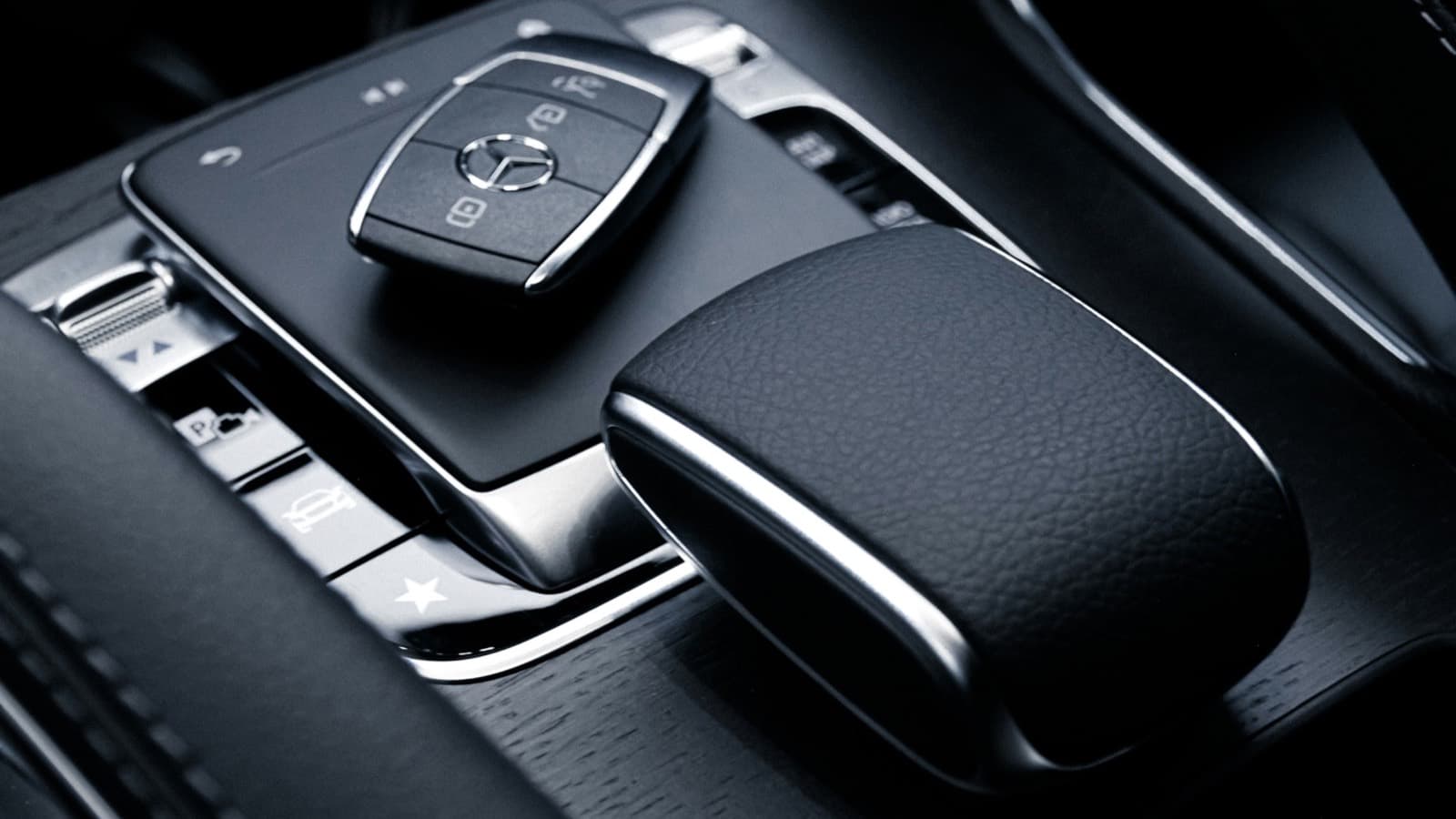 Mercedes key resting on the leather centre console of a premium car